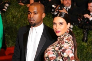 Kanye West, left, with a pregnant Kim Kardashian, right.