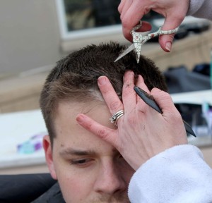 Eric Howard gets a haircut by one of the volunteer stylists for Alpha Sigma Alpha’s sixth annual Buzz-A-Thon fundraiser (Photo by Aaron Berkowitz) 